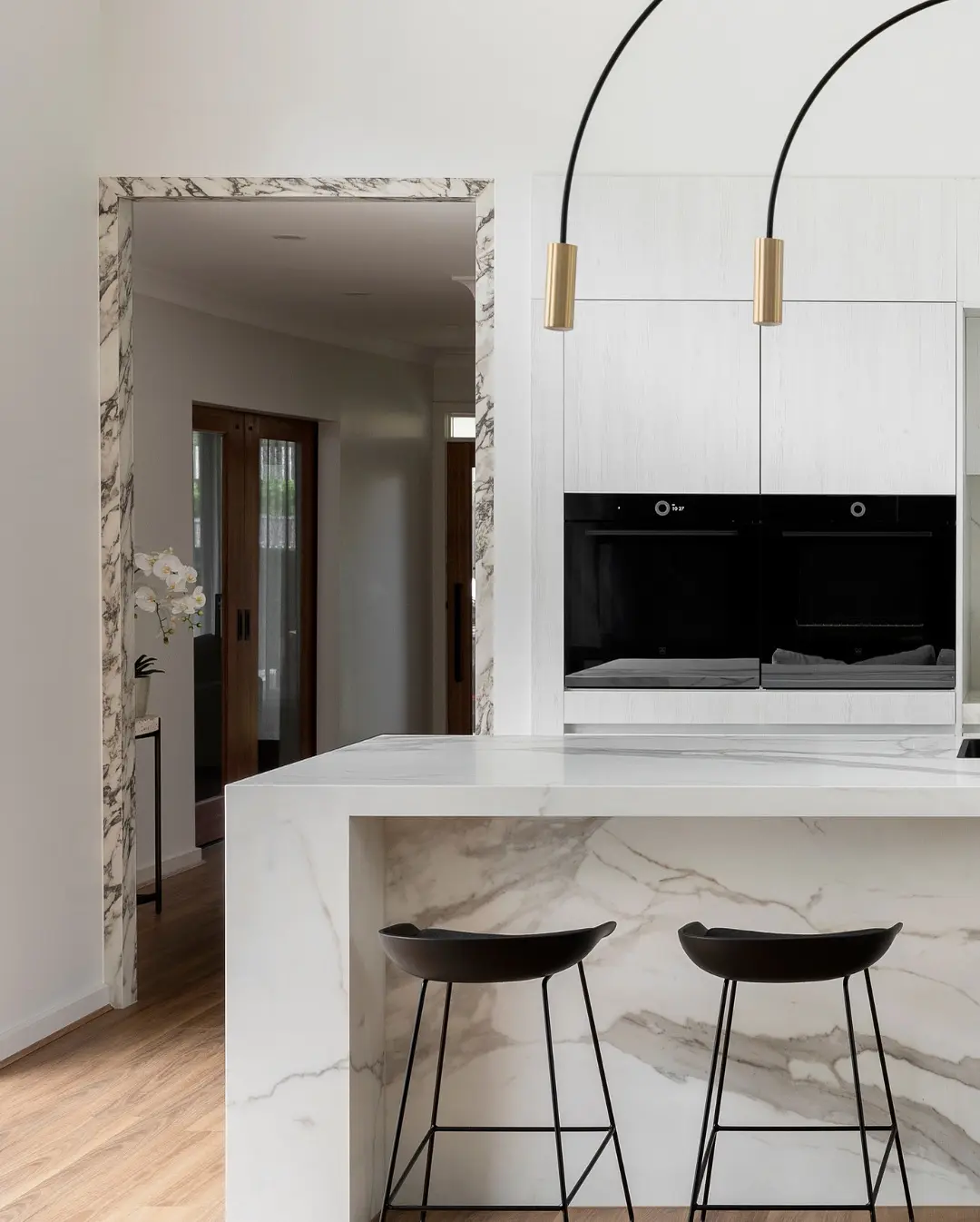Luxury Häcker kitchen island with waterfall marble stone benchtop and white premium cabinetry