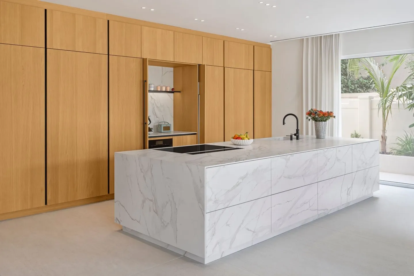 Premium oak timber and marble Häcker kitchen with handleless cabinetry